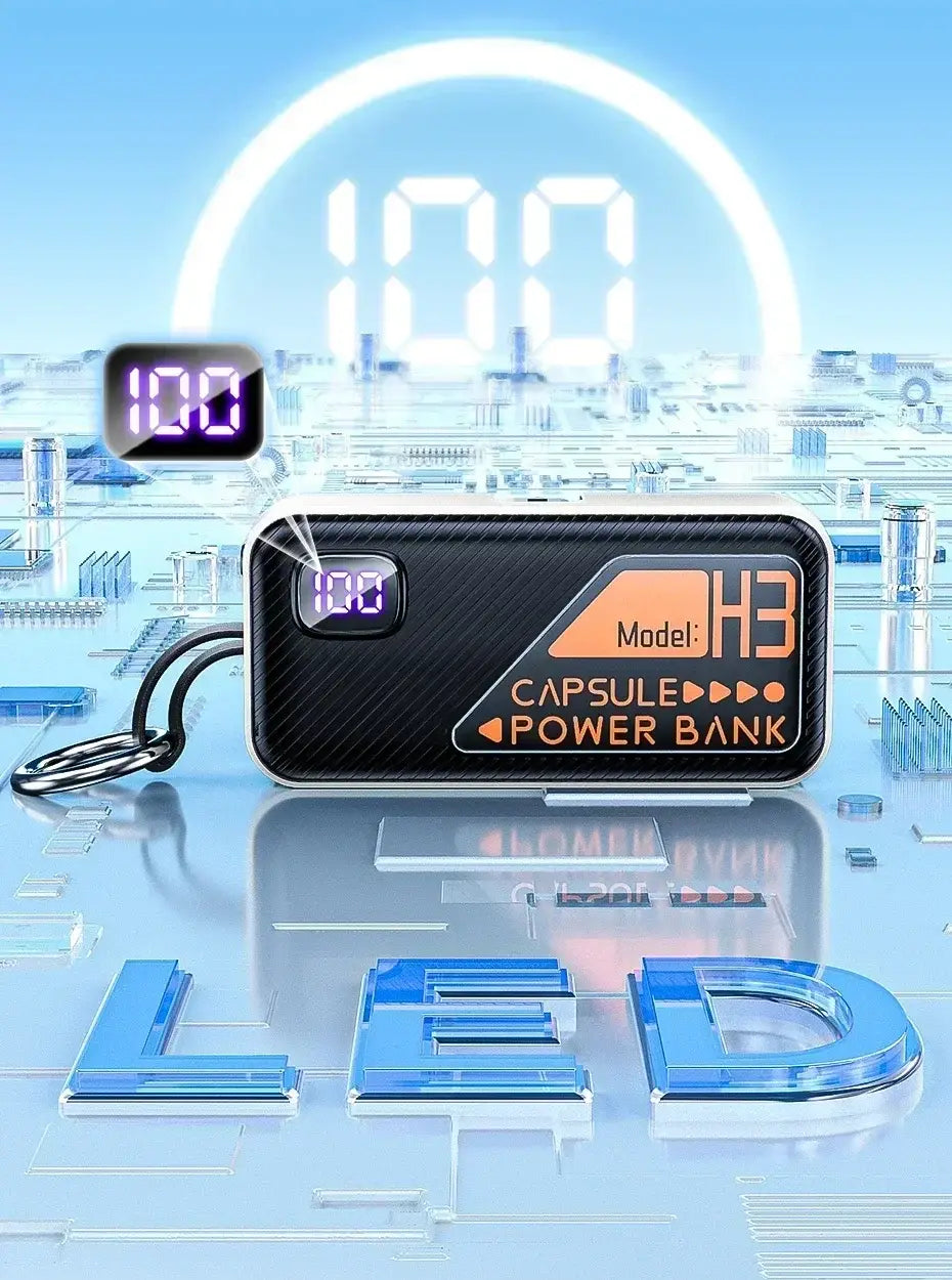 Black carbon-fiber textured capsule-shaped portable power bank with orange branding and a digital display showing 100 percent battery capacity for fast charging.