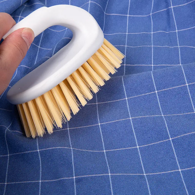 Brosse à manche blanc avec des poils beige clair pour nettoyer le tissu, illustrée avec une chemise habillée Oxford en coton 100 % pour hommes, coupe slim
