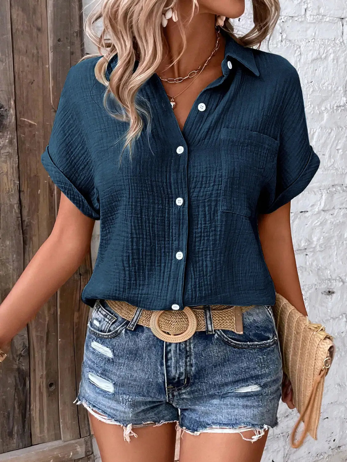 navy blue textured cotton women short sleeve button up shirt with rolled sleeves and chest pocket.