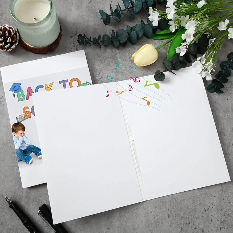 White pop-up greeting card with colorful musical notes design featuring a recordable voice function for wedding and back to school themes.