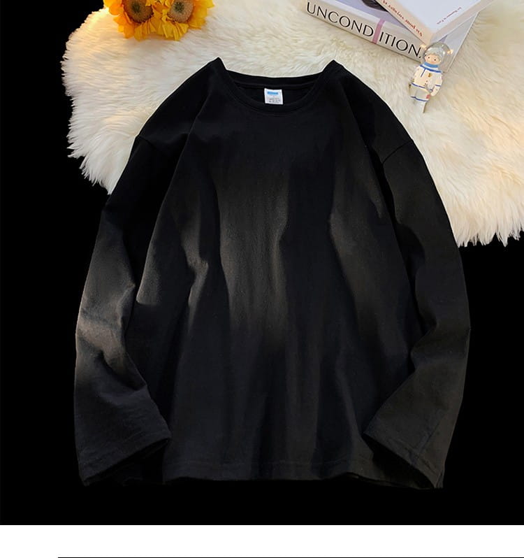 Black oversized long sleeve blank t-shirt with a crewneck and soft slightly faded texture.