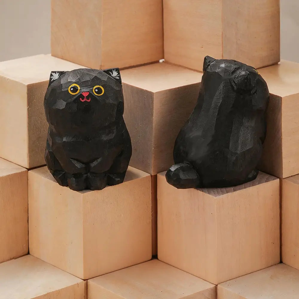 Black stylized handcrafted wooden cat figurines with yellow eyes and pink noses ideal for desk decor available factory direct actual product.