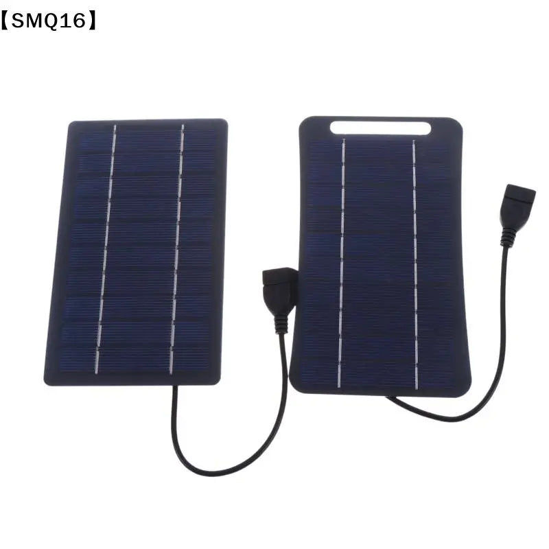 dark blue rectangular solar panel with white grid lines and black usb cables attached designed as a portable usb charging panel to stay connected