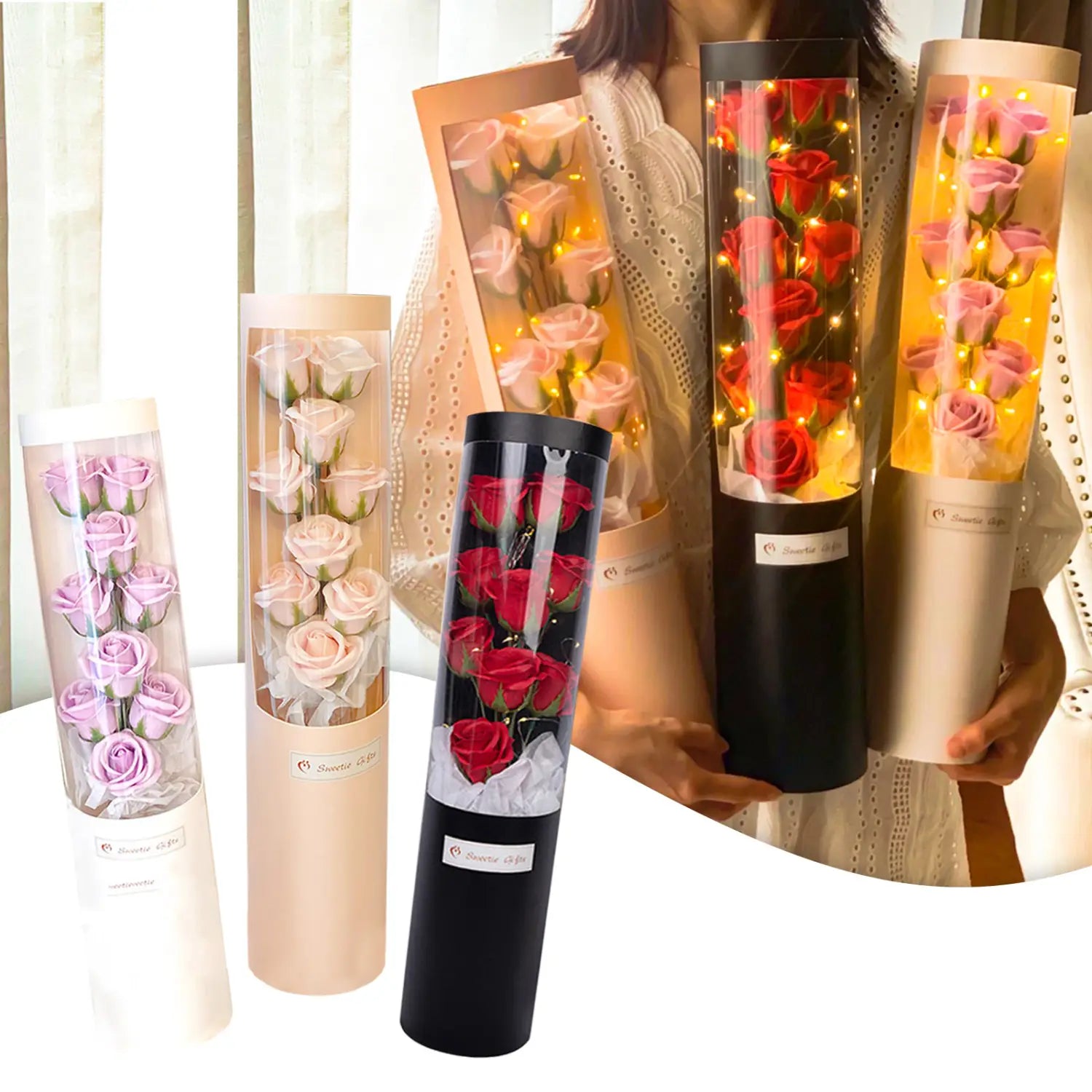 Ein zylindrisches Glasrohr, gefüllt mit künstlichen Rosen in Violett, Blush Pink, Rot und hellem Pink, die von warmen LED-Feenlichtern für eine Rosen-Seifen-Blumen-Geschenkschachtel zum Valentinstag beleuchtet werden.