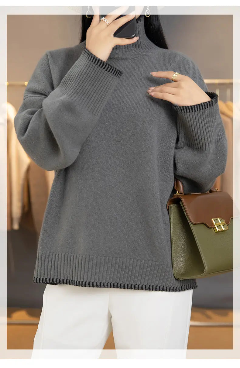 A cozy oversized gray knit pure wool turtleneck sweater for women with ribbed cuffs and hem.