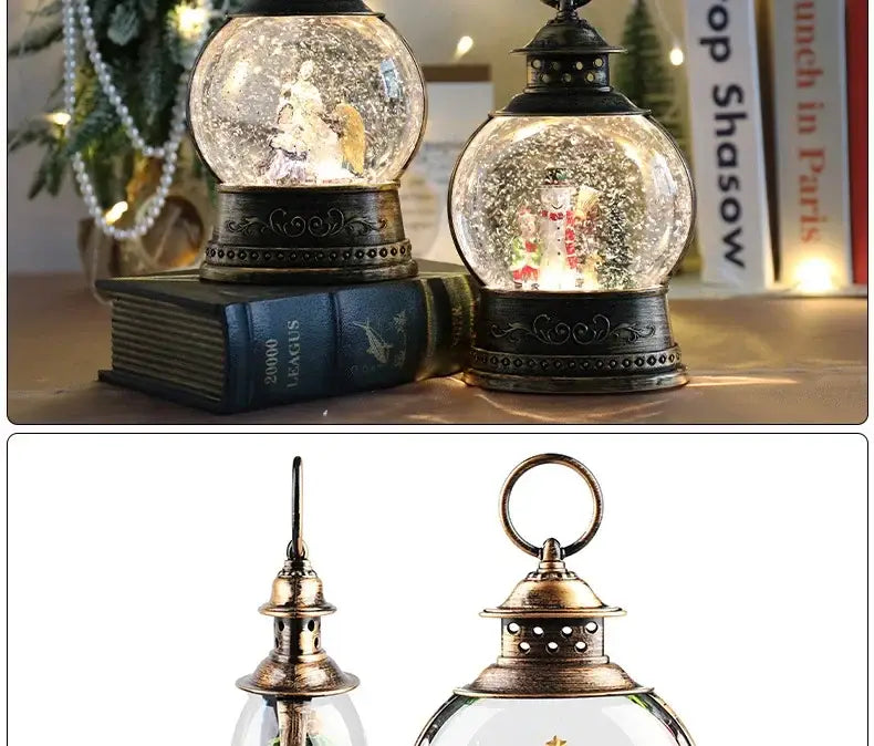 Antique brass lantern style Christmas snow globe music box featuring a clear glass sphere with miniature figurines and intricate metalwork base and top surrounded by swirling faux snow.