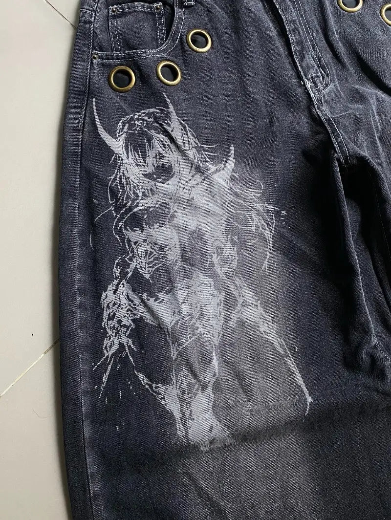 Dark wash denim wide leg jeans for men featuring a white stylized anime character with horns and flowing hair printed across the thigh in a Y2k gothic graphic design.