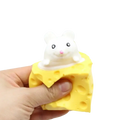 A white plush cheese mouse with black eyes and pink nose sits on a yellow squeeze cheese toy shaped like cheese