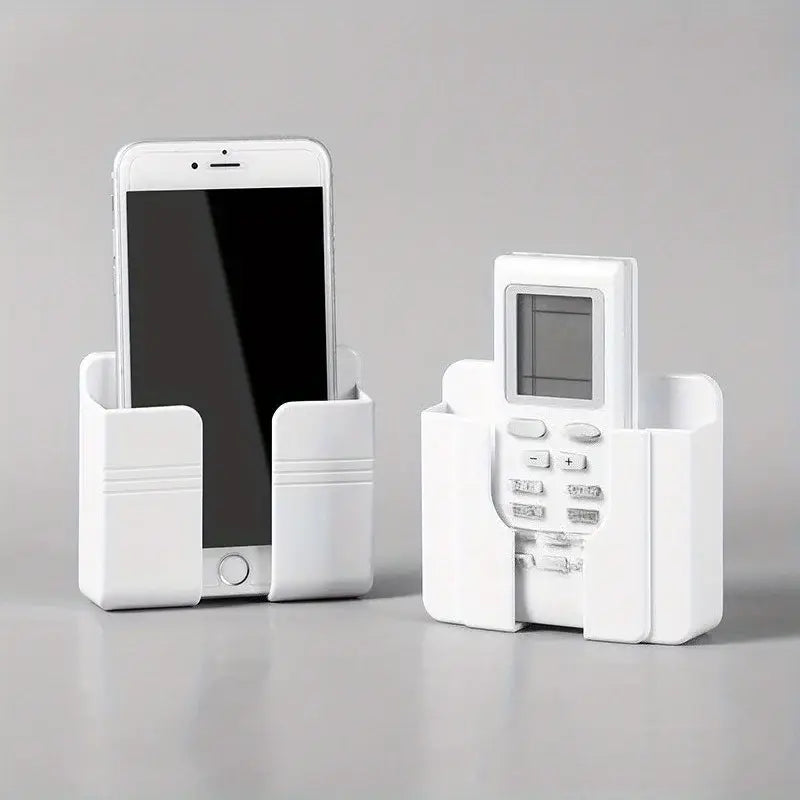 White plastic wall mount phone charging holder with molded slots for secure placement of phone and remote control.