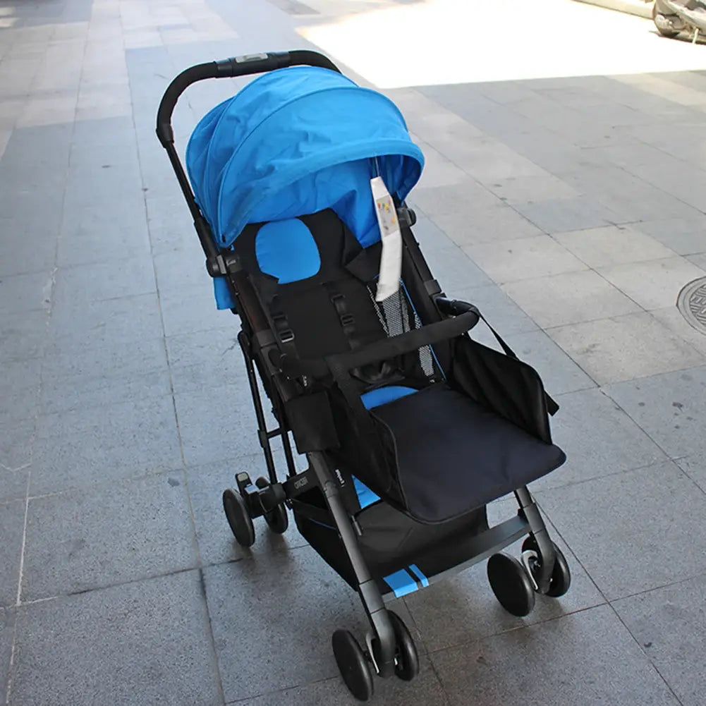 Blue and black foldable universal stroller with seat cushion, canopy, and storage basket featuring an extension footrest infant footboard.