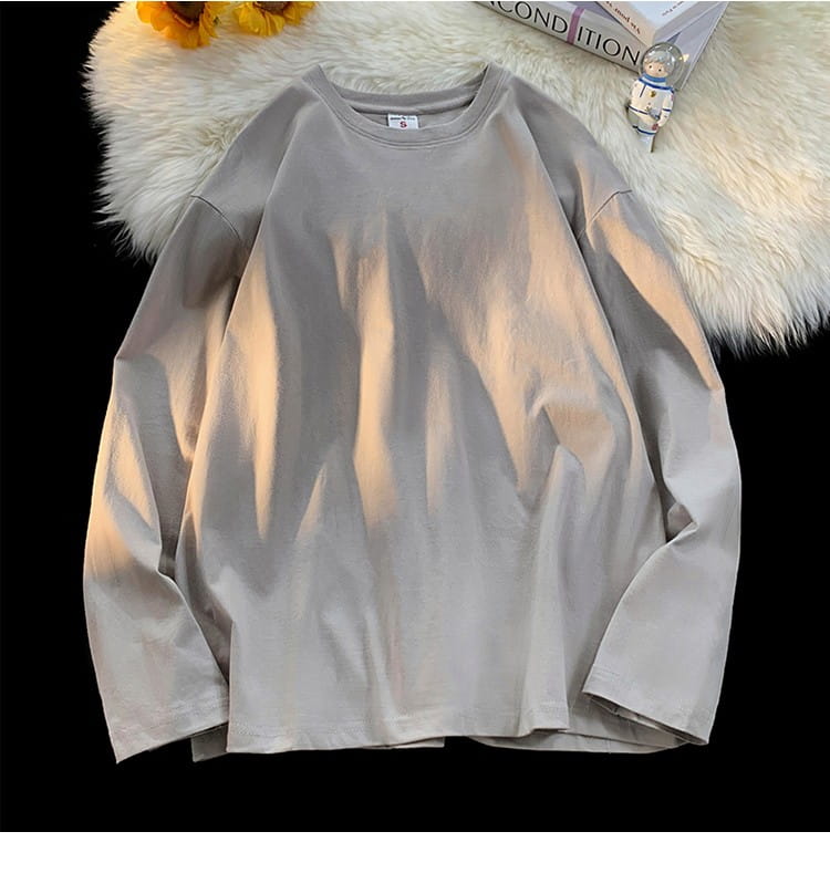 A soft light gray oversized long sleeve blank t-shirt with a relaxed fit crewneck and subtle fabric texture.
