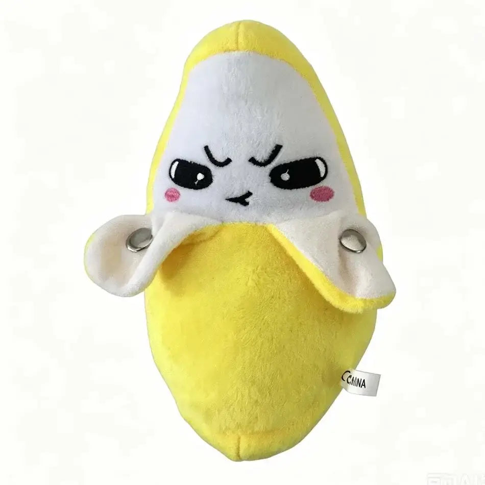 A yellow plush fruit coin purse stuffed animal toy featuring a white face with black eyes, pink cheeks, and silver snap buttons on its peel.