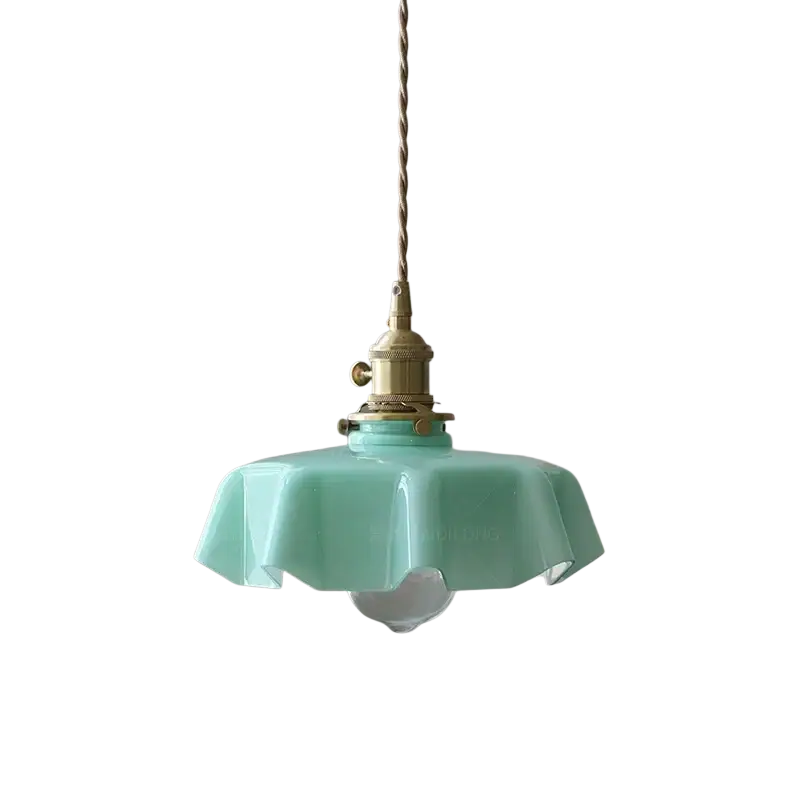A mint green ruffled glass pendant light with a brass finished fixture and twisted chain for dining or bar lighting