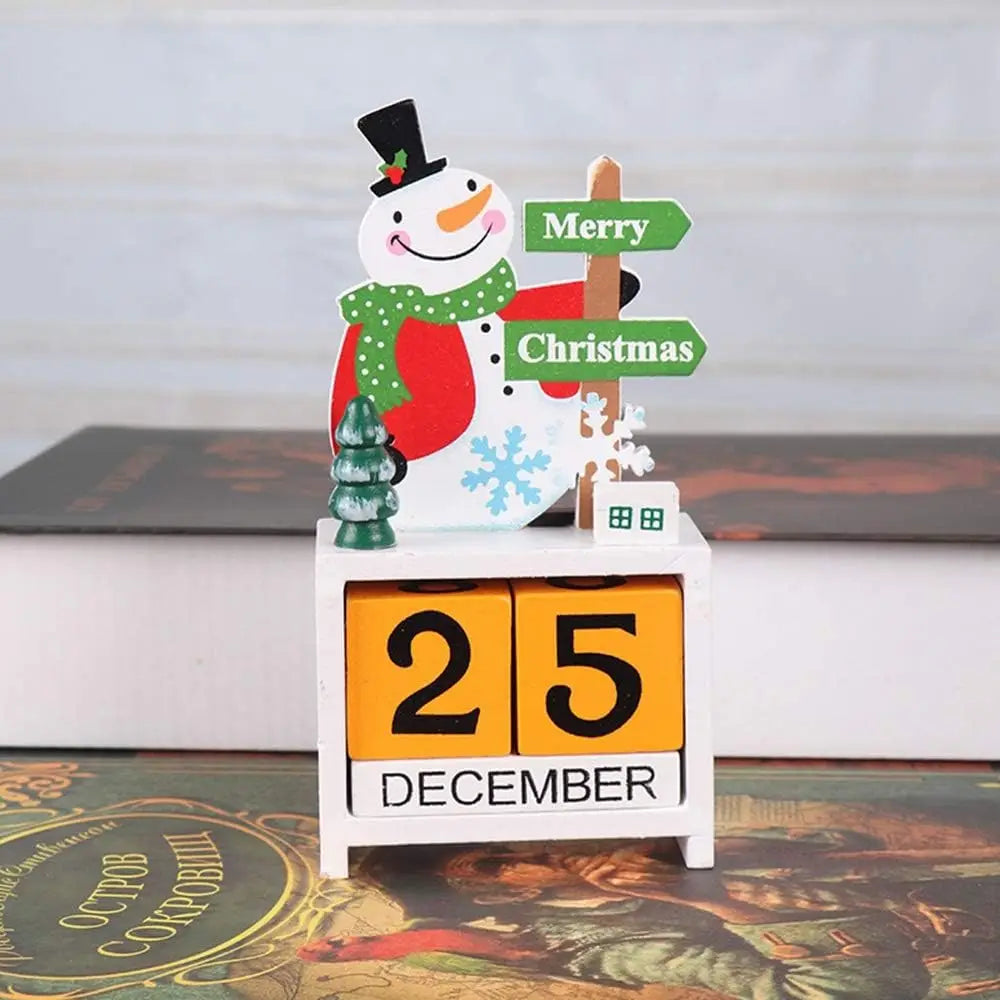 A festive wooden Christmas countdown calendar block featuring a red coat, green scarf, and black top hat snowman atop a white base displaying 25 December on orange blocks.