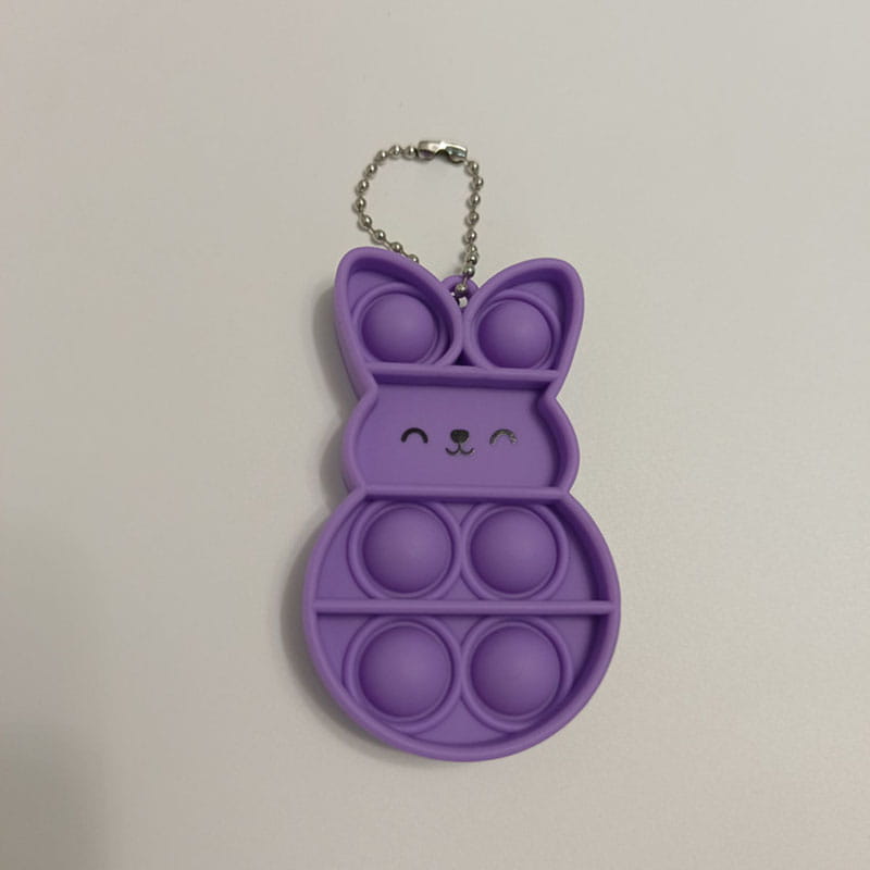 Purple rabbit pop it fidget keychain with bunny shape and silver chain for portable sensory play.
