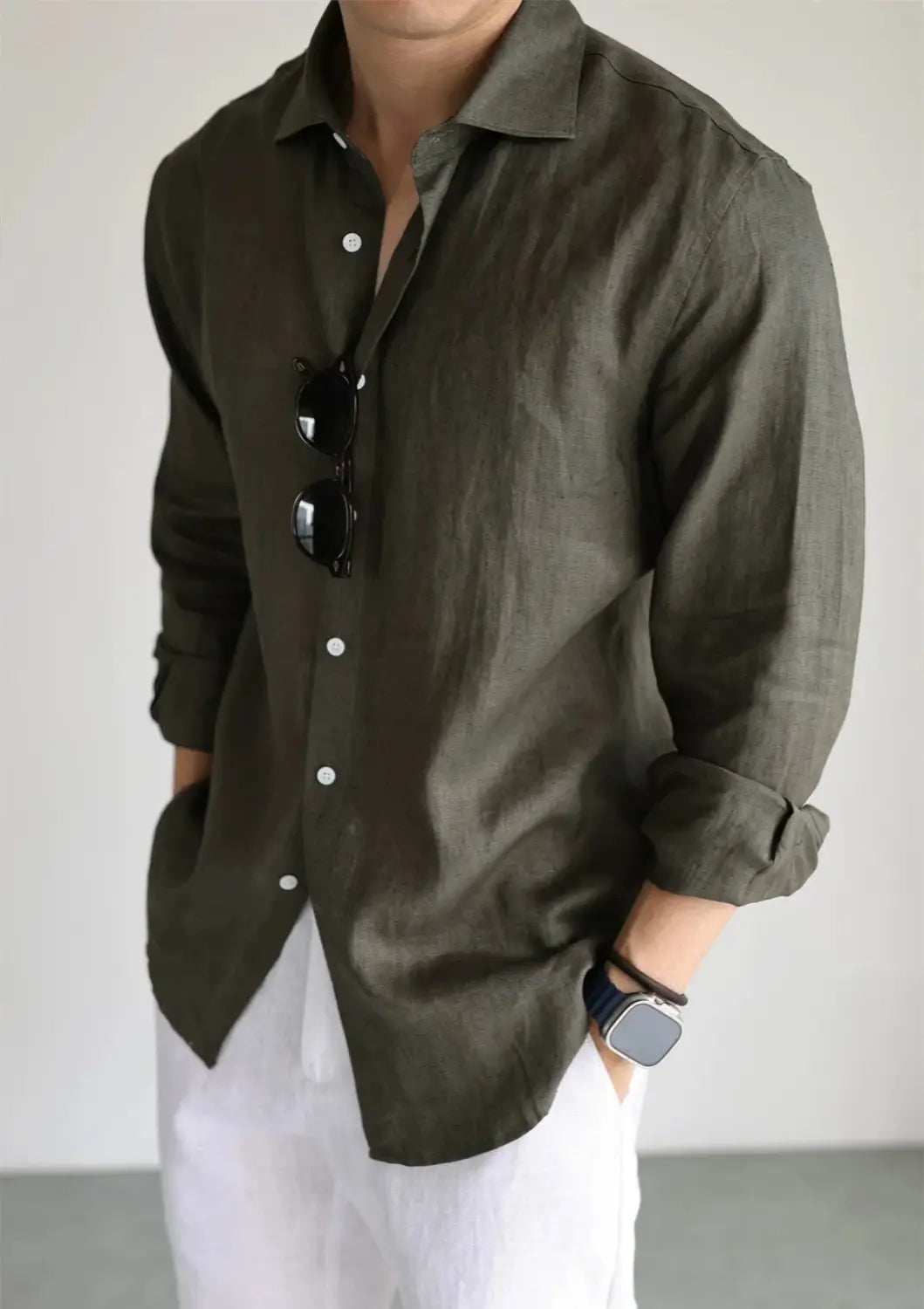 Men cotton linen casual button down shirt in olive green with rolled sleeves and white buttons.