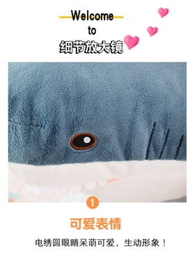 Plush blue shark stuffed animal pillow featuring embroidered eyes and stitched gill slits made of soft plush material.