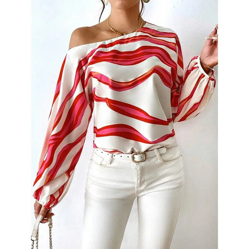 A vibrant red and white wavy-striped satin slash neck blouse with one-shoulder sleeve style design.