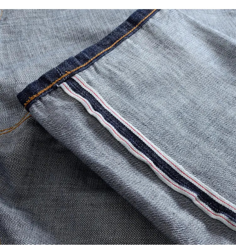 Light-wash heavyweight red selvedge denim jeans featuring a classic double-stitch seam with contrasting dark blue white and red thread.