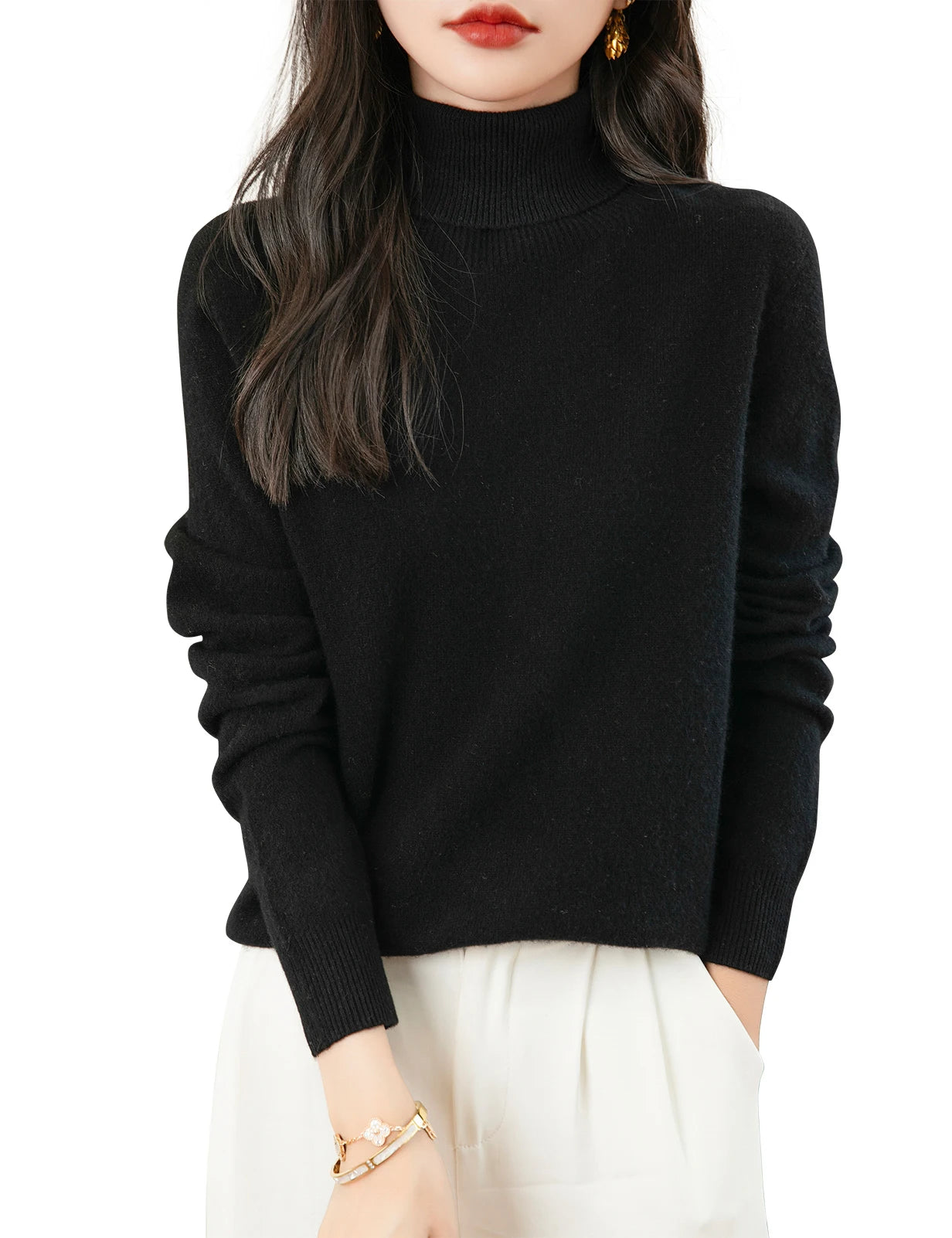 Black merino wool turtleneck sweater for women with long sleeves and ribbed cuffs.