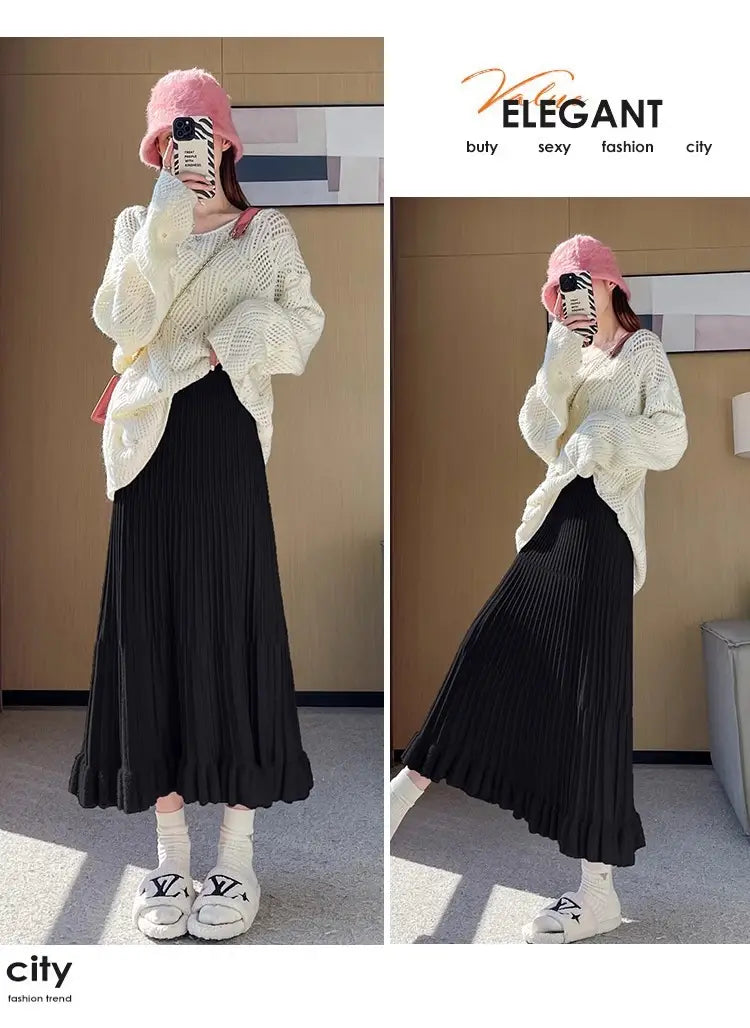 Jupe mi-longue en maille noire plissée, à taille haute et silhouette parapluie élégante et fluide.