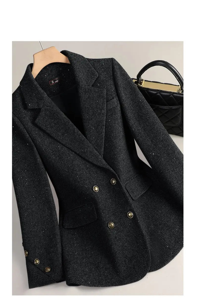 Black wool blend double breasted blazer with textured fabric and gold toned buttons.