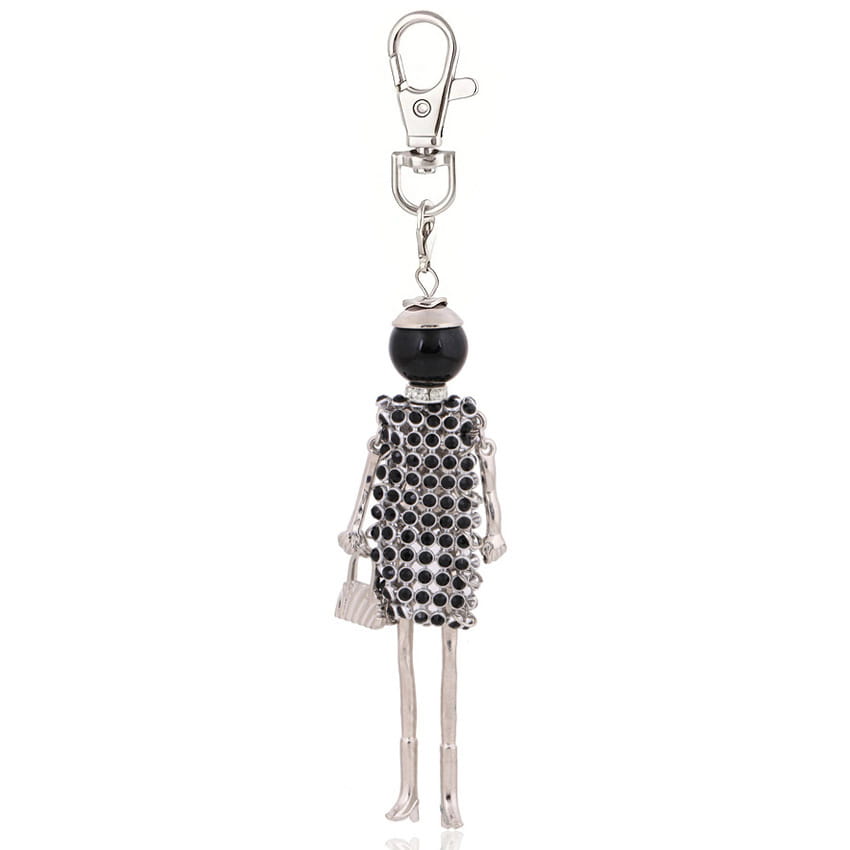 Silver skeleton figure rhinestone doll keychain featuring a black beaded head and dress adorned with sparkling black rhinestones, holding a tiny silver handbag.