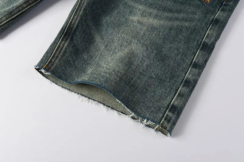 Men’s distressed blue acid wash denim shorts in dark-wash fabric with a frayed hem and visible stitching.