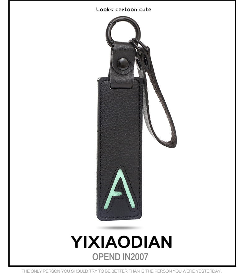 Black leather letter keychain with a light green embroidered letter a and a metal ring ideal as an alphabet pendant party gift.