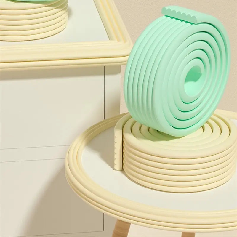 A coiled mint green silicone baby safety edge protector strip 2m with a ridged flexible design.