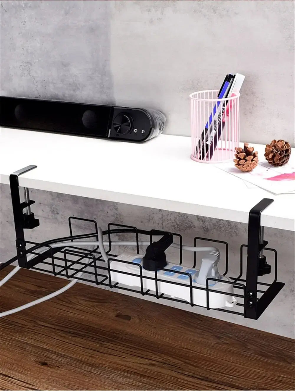 Black metal wire shelf organizer with adjustable clamps and grid design for under desk cable management tray.