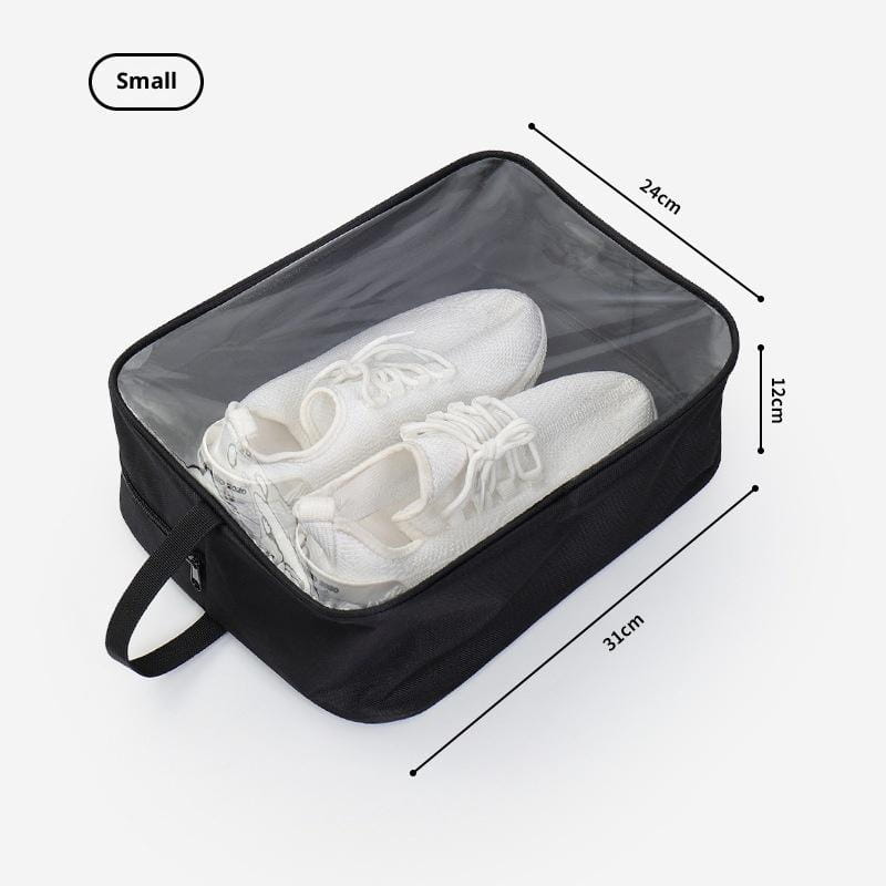Sac de voyage imperméable rectangulaire noir pour chaussures, avec panneau frontal transparent et poignée, conçu pour ranger une paire de baskets blanches.