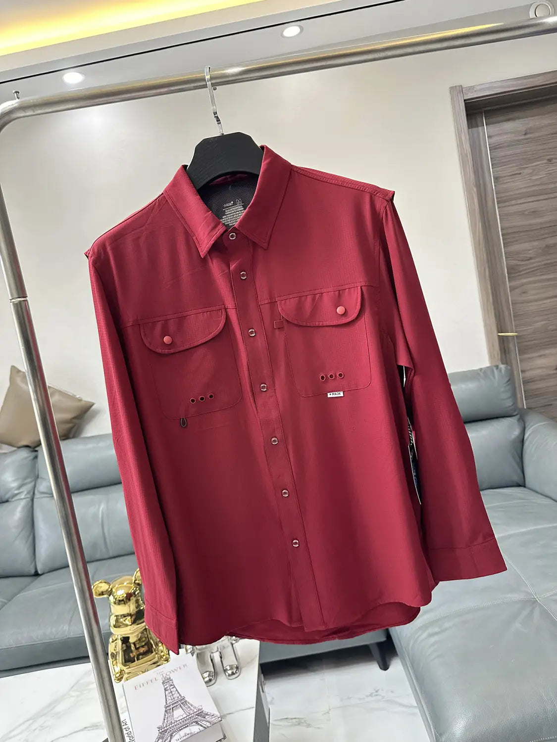 A rich red men’s tactical outdoor long sleeve shirt with button-up front and two chest pockets featuring buttons and subtle stitching details.