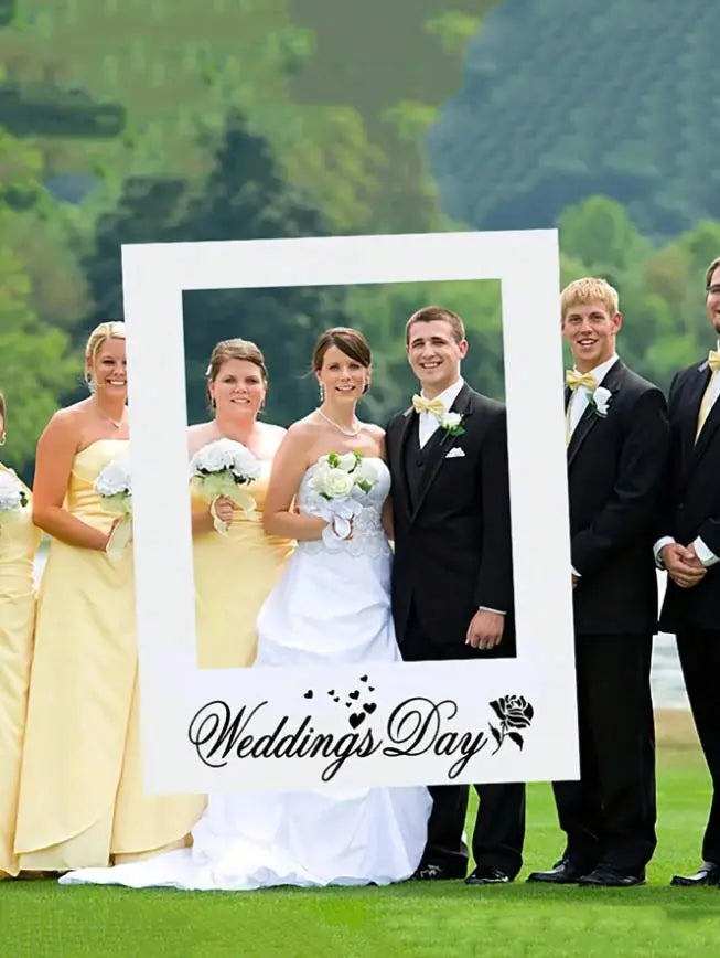 Atrezzo de marco rectangular blanco para fotografía de boda con el día de la boda en texto de guion cursivo negro y un pequeño diseño de rosa debajo del texto.