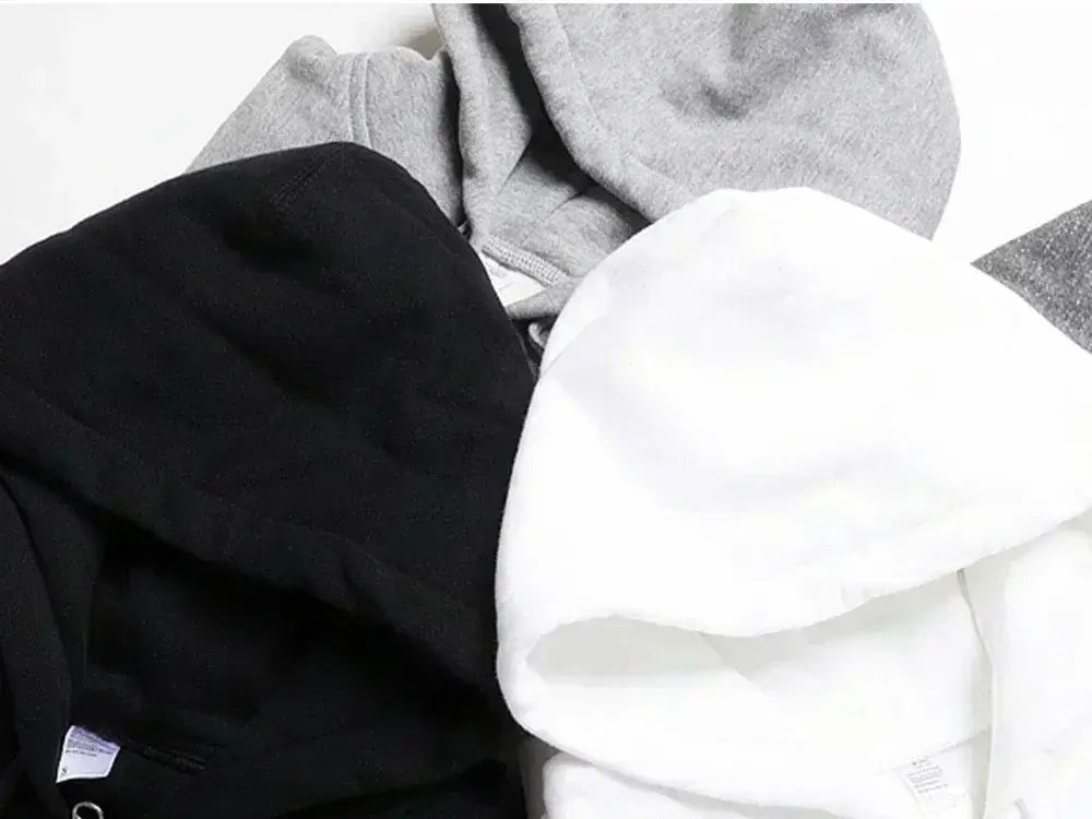 Three oversized v back graphic hoodies in black white and heather gray fabric showing the back side designed for streetwear pullover use.