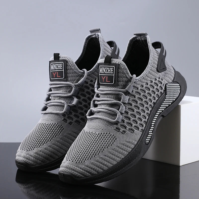 Men breathable slip-on mesh sneakers in gray with black accents and a textured sole featuring the minzhe yl logo on the tongue.