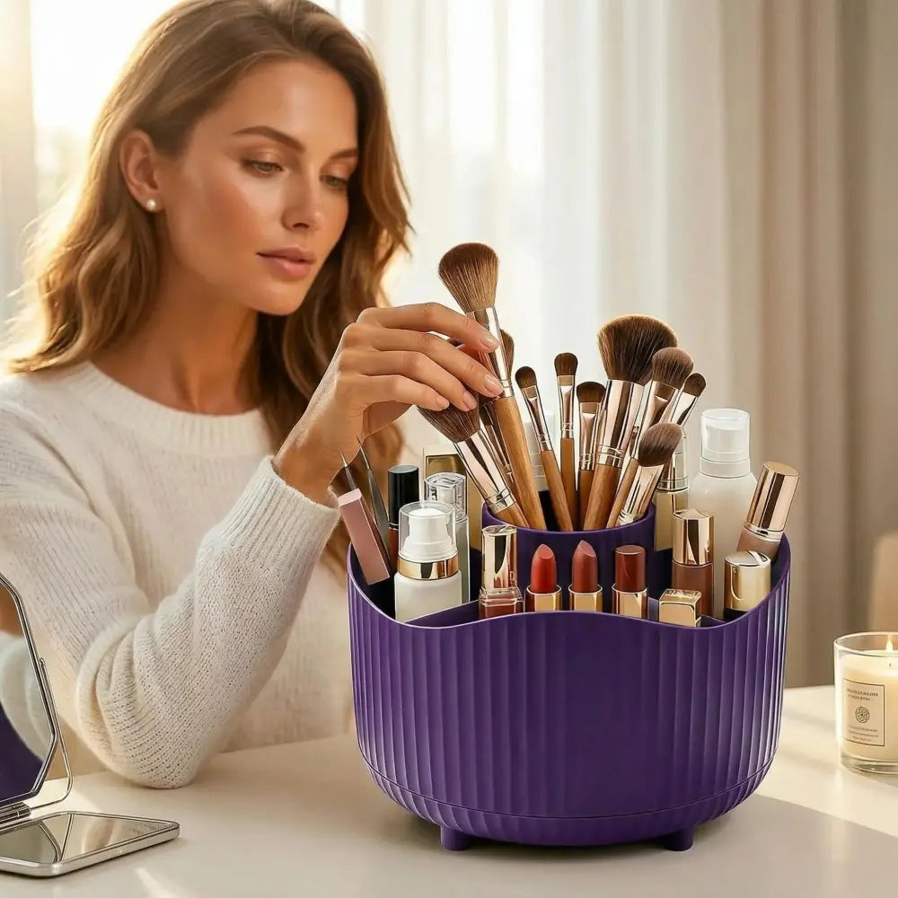 Purple rotating makeup organizer made of ribbed plastic in purple color with multiple compartments holding brushes lipsticks and skincare bottles.