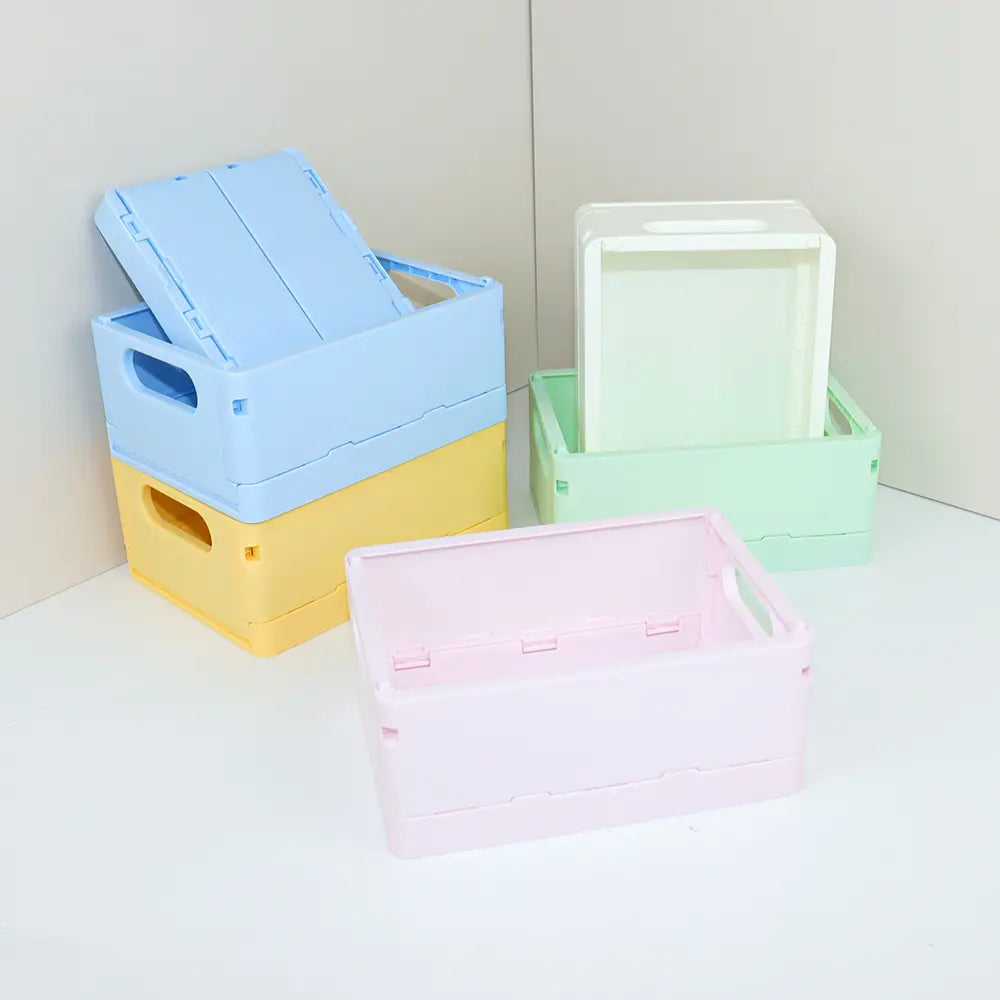 pastellfarbene faltbare Kunststoff-Aufbewahrungsboxen in sanften Blautönen, Gelb, Mintgrün und Rosa, verwendet als Desktop-Organizer