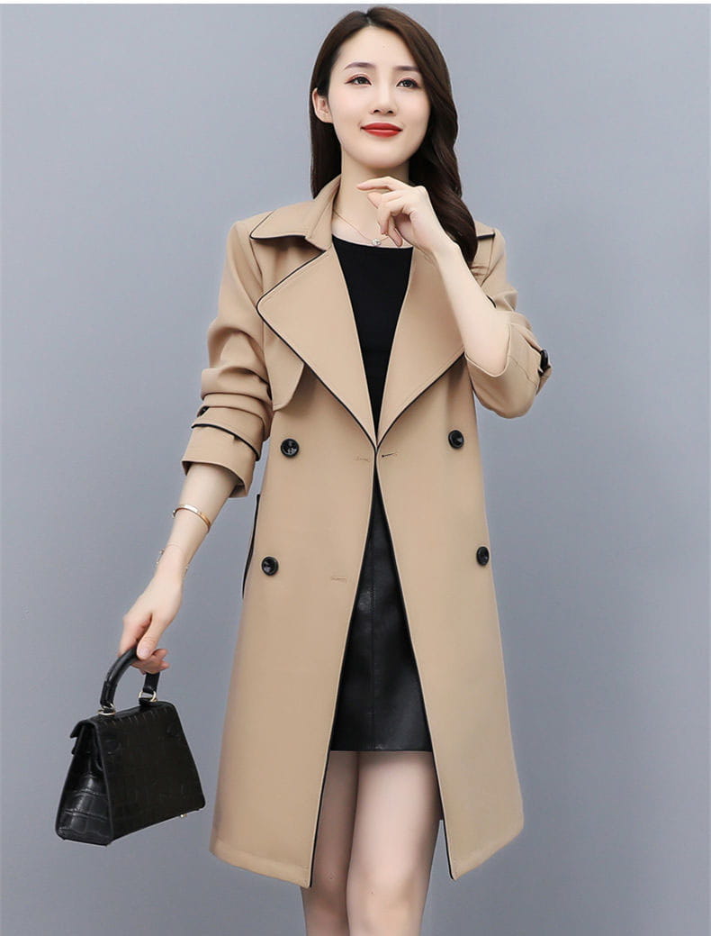 Beige women double breasted trench coat with black buttons and rolled up sleeves made of lightweight material for stylish outerwear.