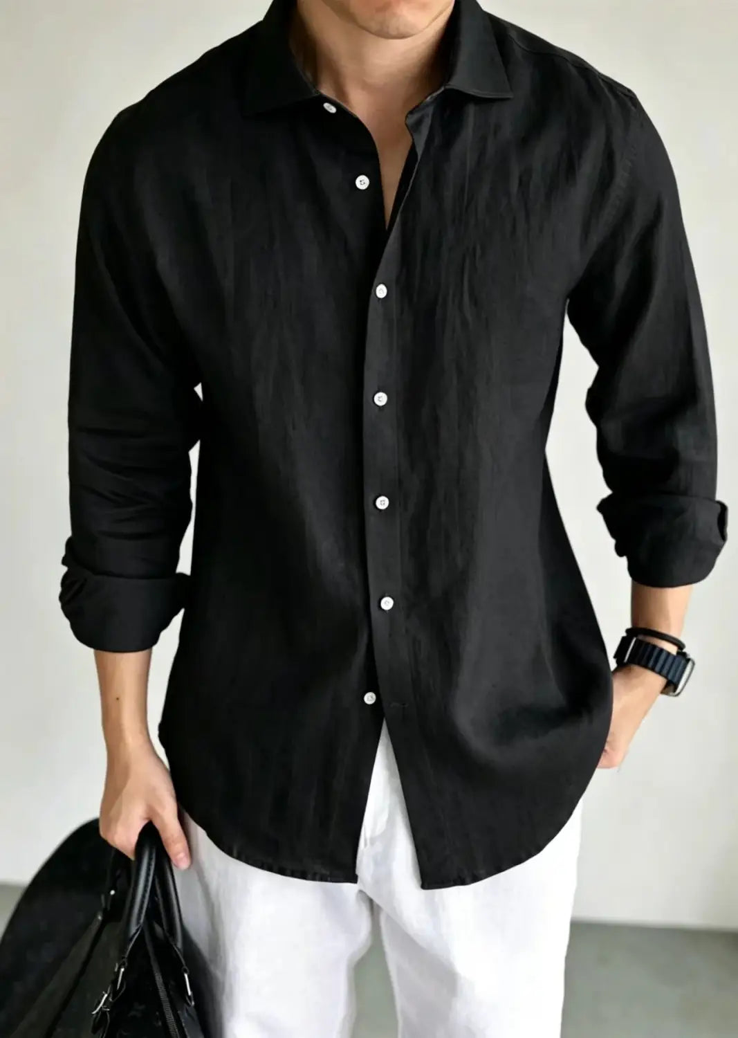 Black long-sleeved men cotton linen casual button down shirt with subtle textured weave and white buttons.