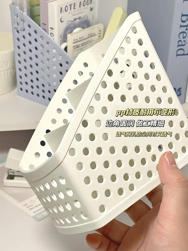 White triangular plastic desktop stationery organizer with perforated design and rounded edges for makeup and pen storage.