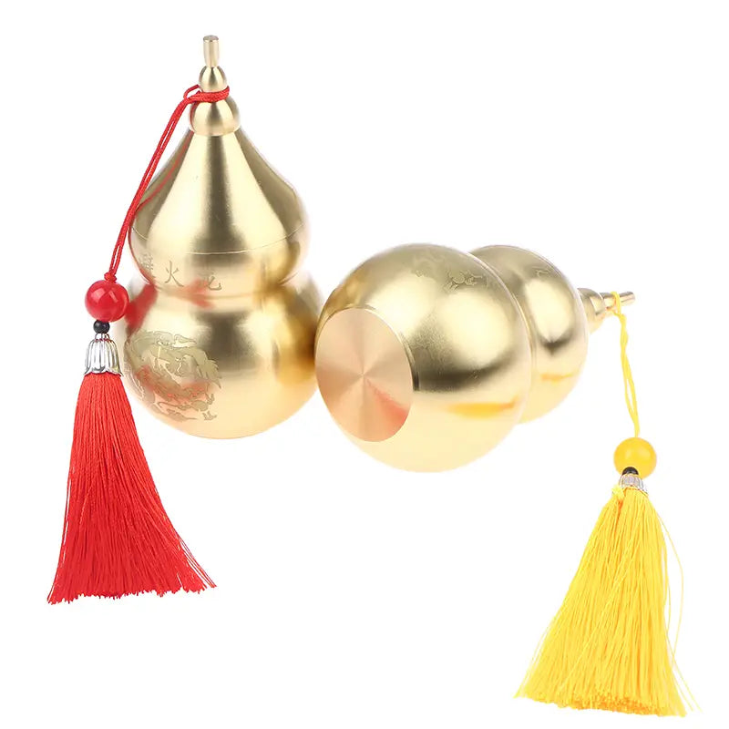 golden metallic brass gourd feng shui prosperity ornament with red and yellow tassels displayed in front view
