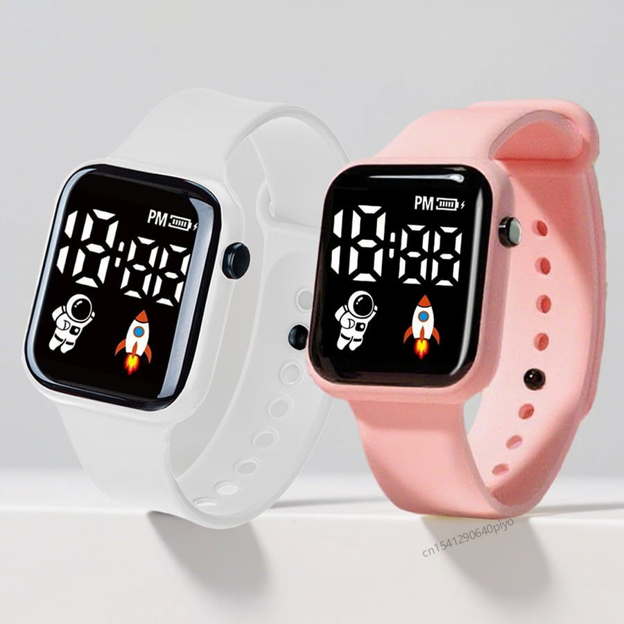 Montre électronique à bracelet rose et blanc pour garçons et filles, avec graphiques d’astronaute et de fusée sur l’écran de montre numérique LED de type sport