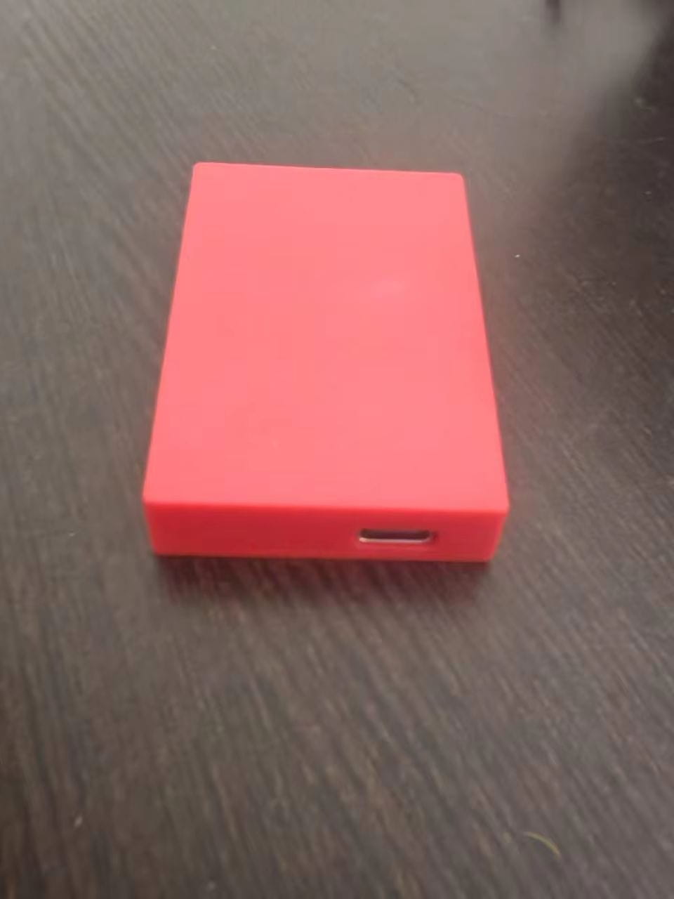 Red rectangular external hard drive with a usb-c port on the side for use as a game card storage box v2 pink accessory case.