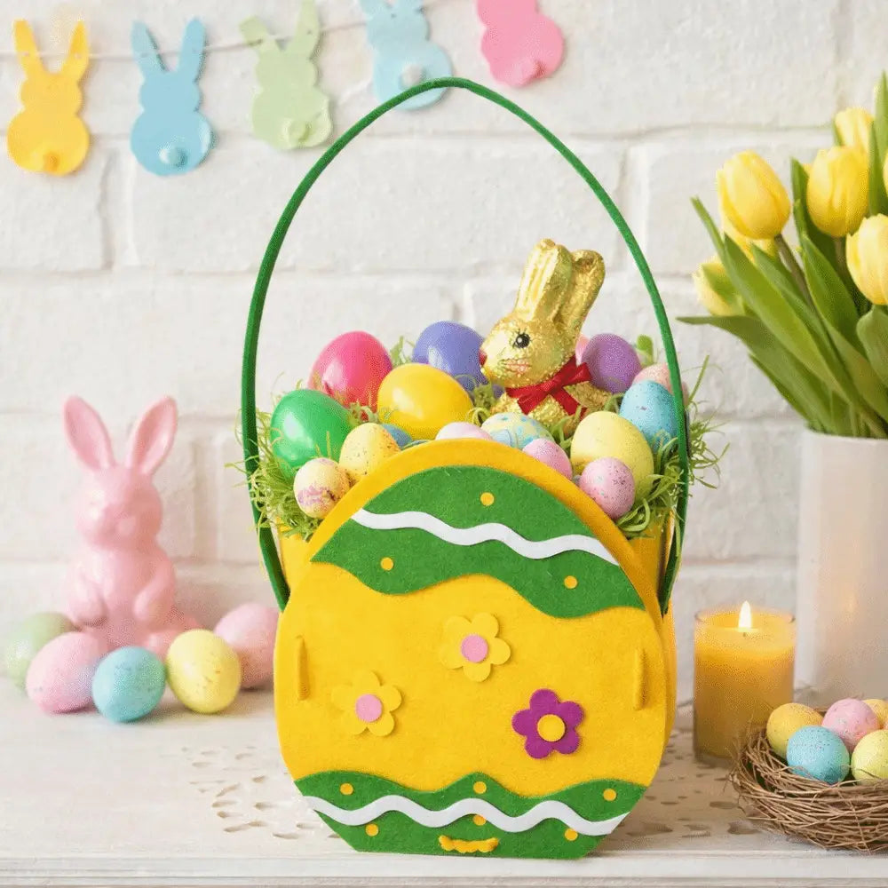 Yellow felt Easter bunny basket gift bag shaped like an egg with yellow and green felt, decorative flowers, wavy patterns, and a green handle.