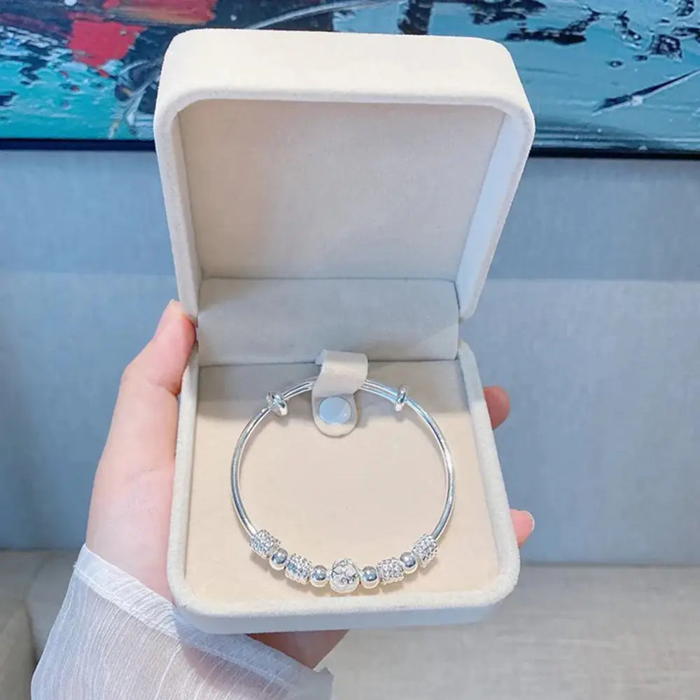 Sterling silver exquisite beaded bangle bracelet for women featuring sparkling crystal beads and a central charm displayed in a white velvet box ideal as a party gift.