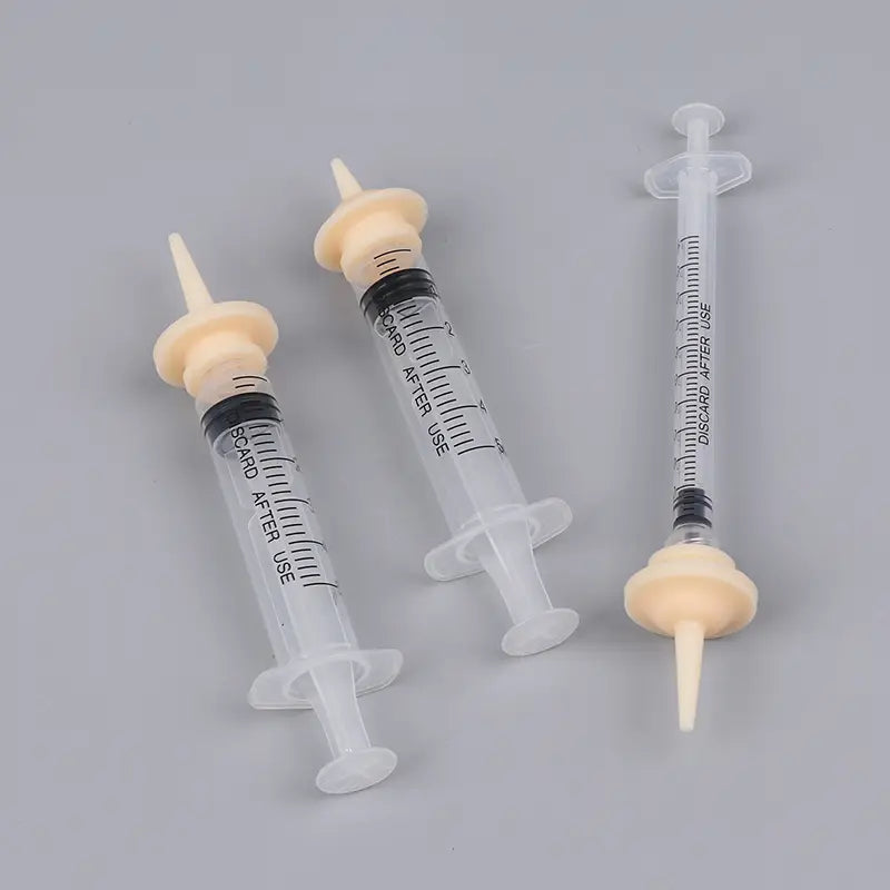 three transparent plastic oral syringes with beige caps and black measurement markings labeled discard after use available in 1ml 3ml 5ml sizes for pet oral syringe silicone nipple feeder use