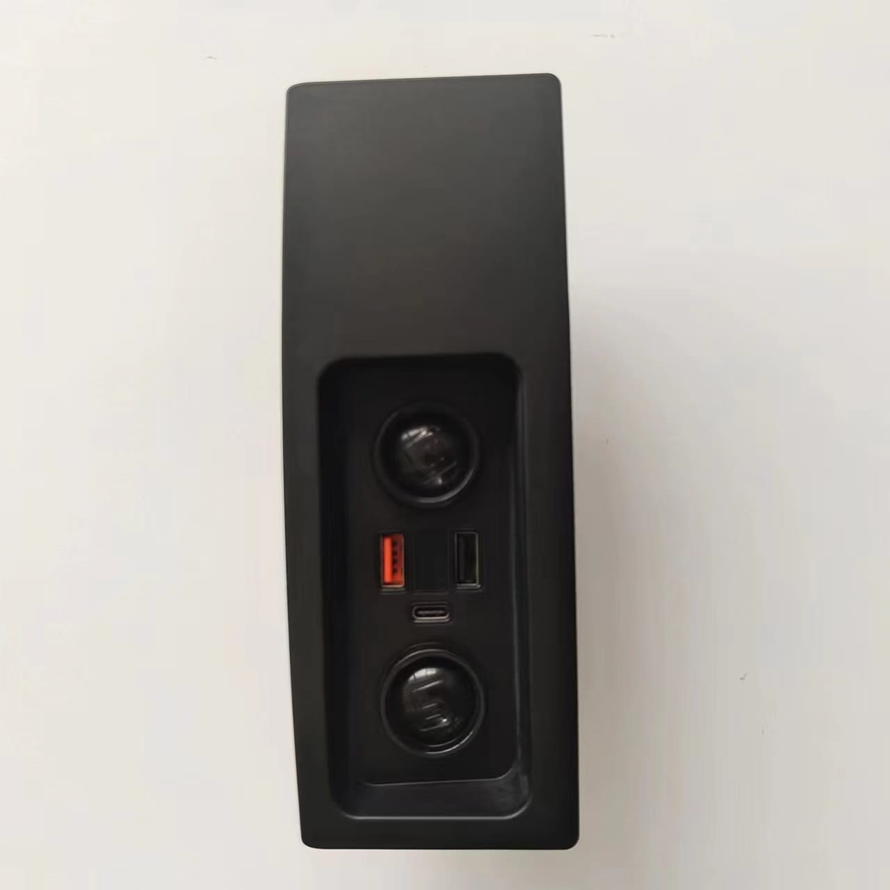 black rectangular car audio control panel with two circular knobs and usb micro-usb and orange ports on the back side of an audi a6 c7 rs6 s7 wireless car charger pad