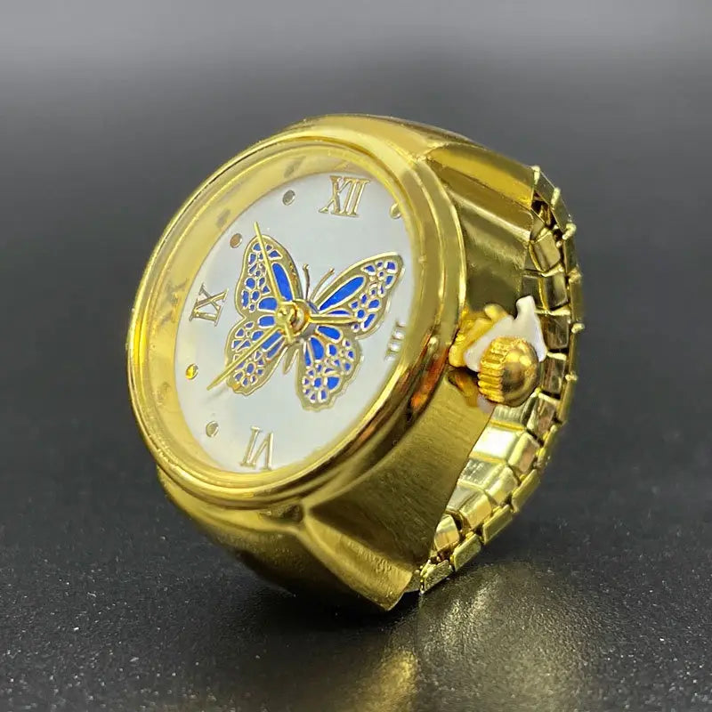 Gold-toned butterfly watch ring made of stainless steel featuring a white dial with roman numerals and blue enamel accents as cute jewelry.