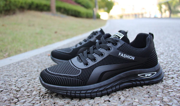 Men breathable athletic sneakers running shoes in black mesh and synthetic leather with fashion and sport branding on the side.